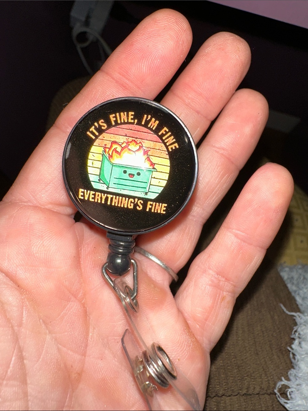 “It’s fine, I’m fine, Everything’s fine” badge reel; dumpster fire. ER